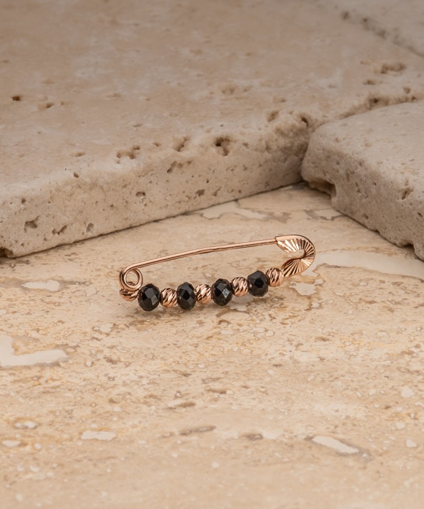 Золотая брошь с ониксами