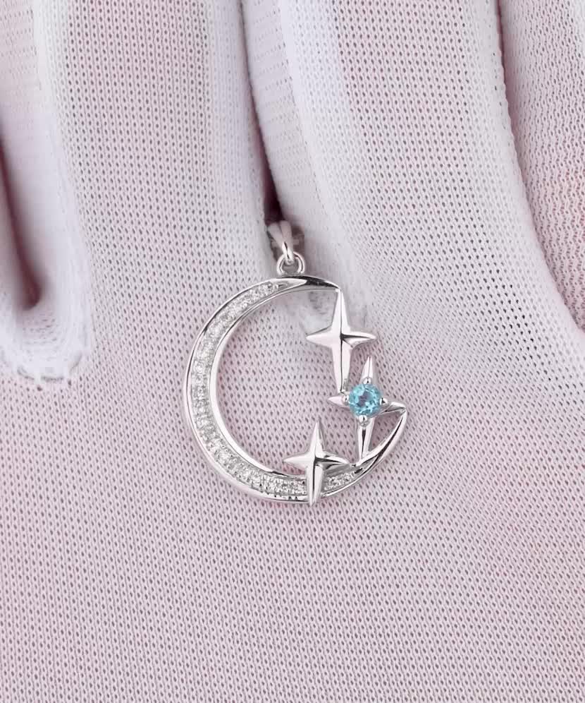 Baltā zelta kulons ar dimantiem un topāzu